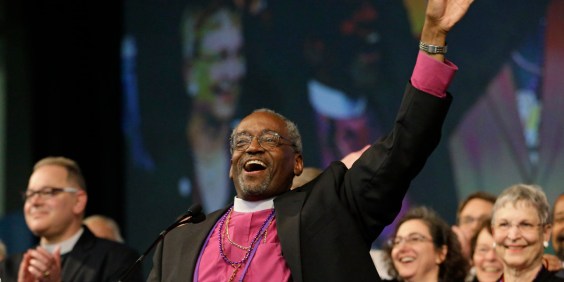Bishop Michael Curry, of North Carolina, waves to the crowd after being elected the Episcopal Church's first African-American presiding bishop at the Episcopal General Convention Saturday, June 27, 2015, in Salt Lake City. Curry won the vote in a landslide. (AP Photo/Rick Bowmer)